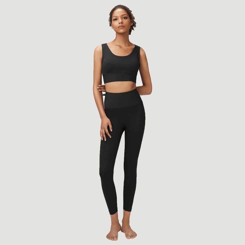 Woman modeling seamless yoga gear set, sports bra and leggings in black. Ideal for active women in yoga and running. Product code SF2086.